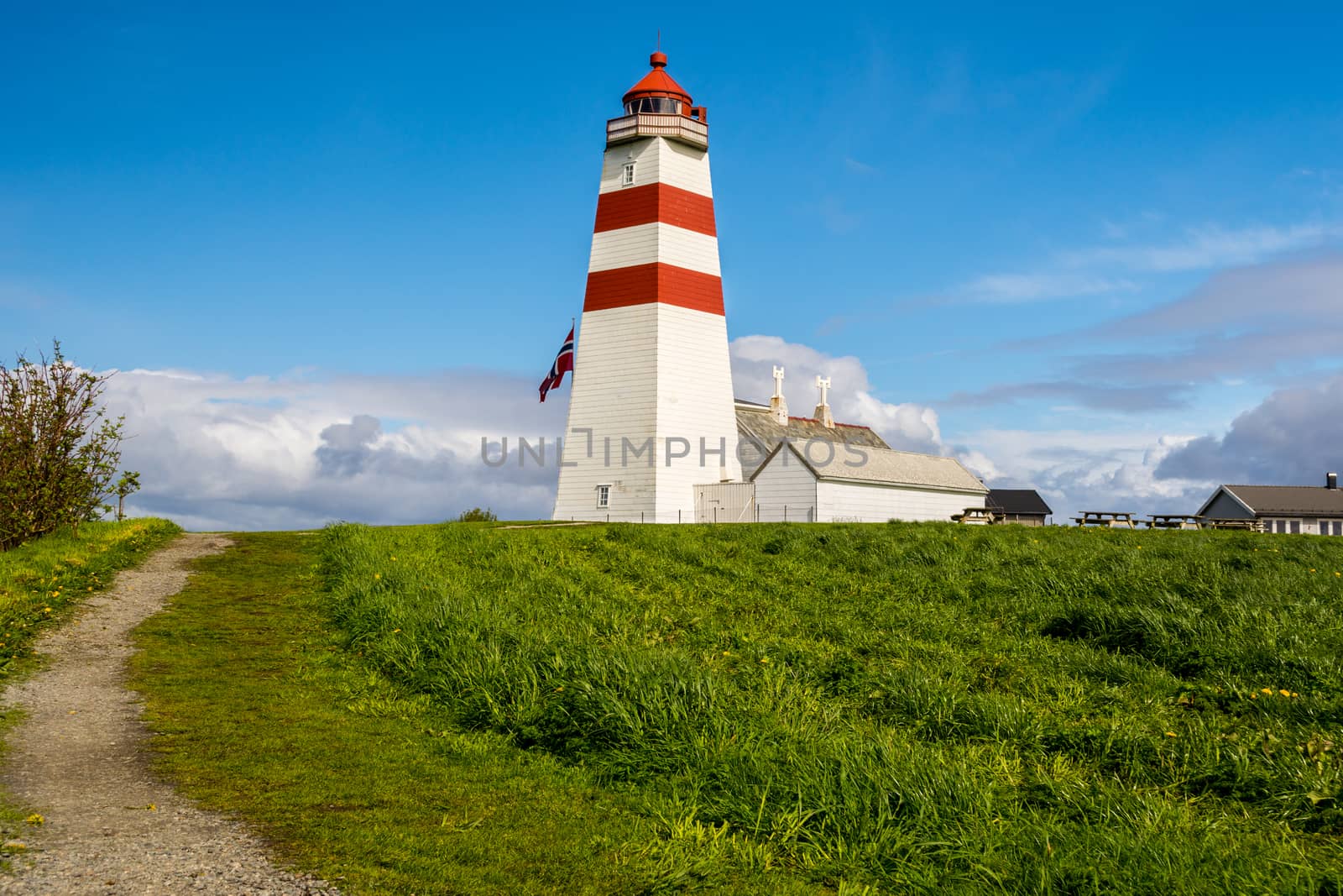 Alnes lighthouse was established in 1852 to guide fishing boats safely to the harbor of the small fishing community of Alnes on Godøy island on the west coast of Norway. by kb79