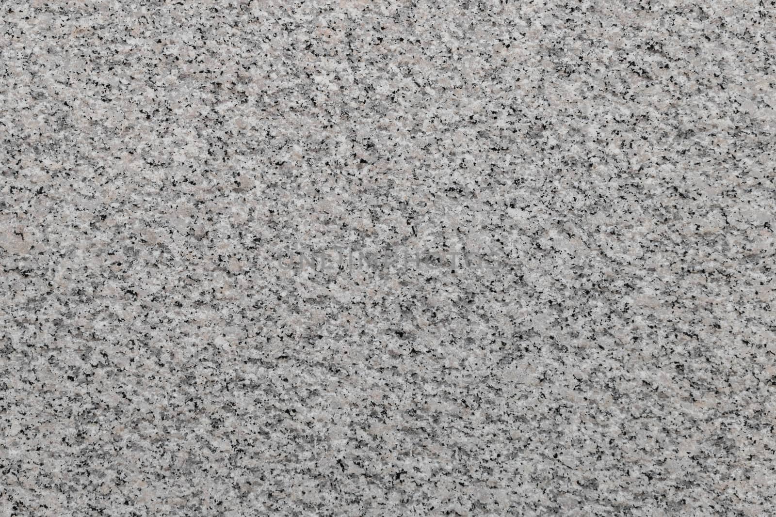 Polished variegated granite texture. It can be used as background.