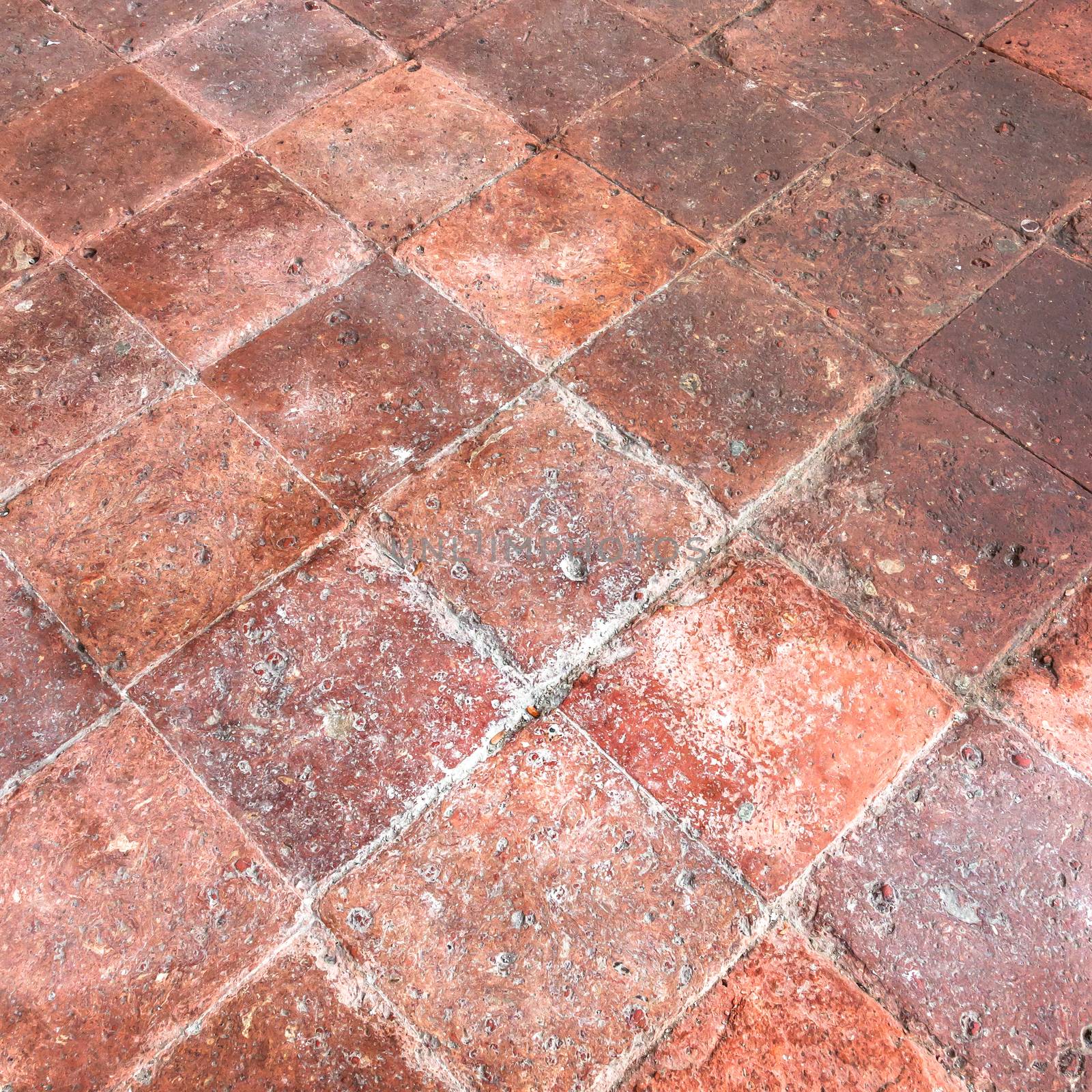 Rustic floor with old tiles inside an Italian country house