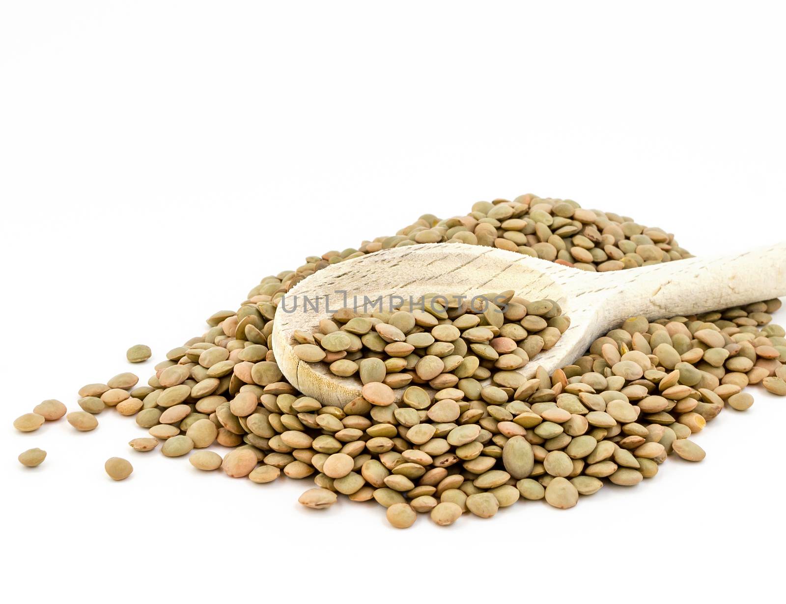 Heap of green lentil isolated on white background with wooden spoon