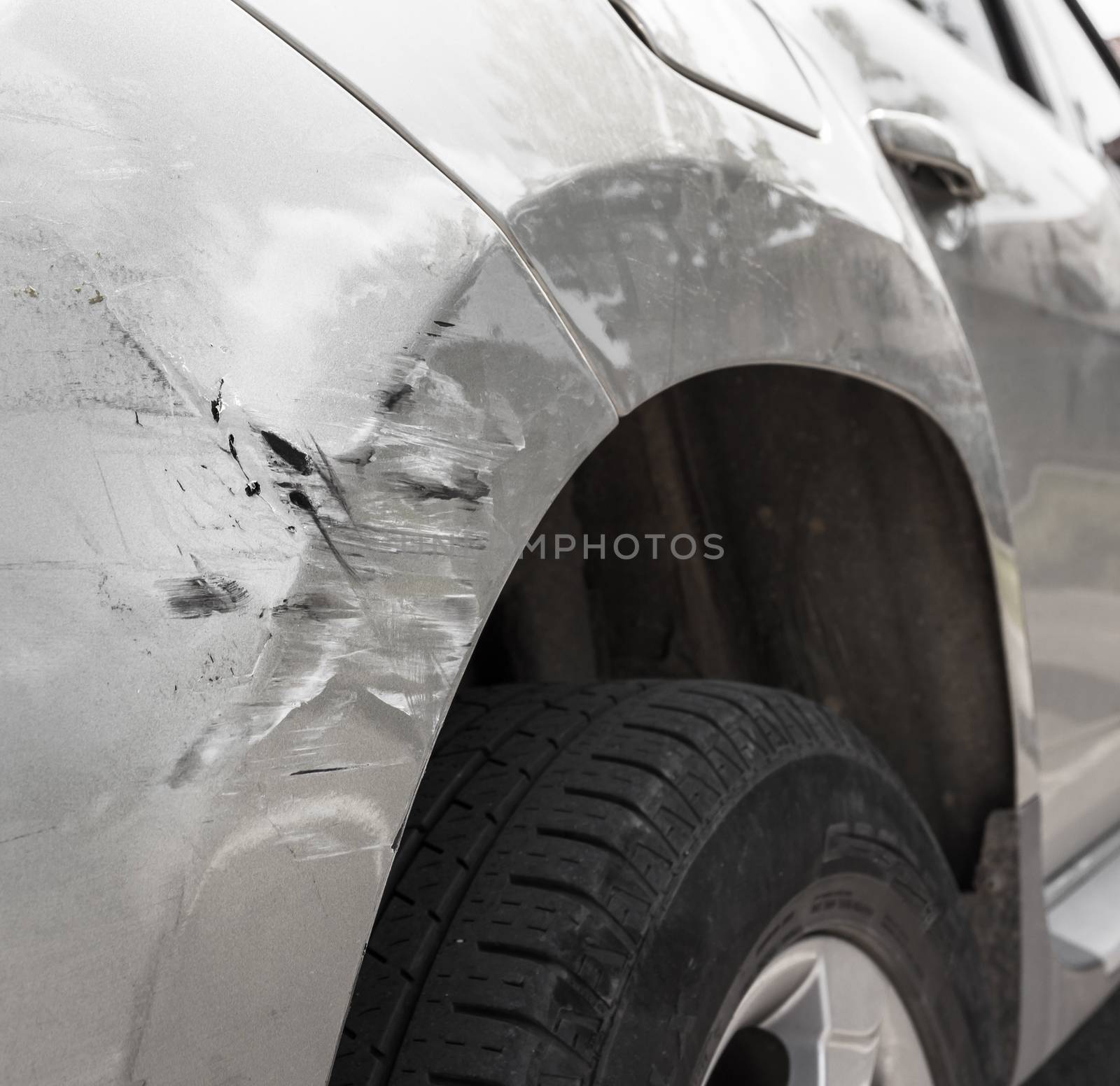 Dents on the car caused by the accident. Close-up.