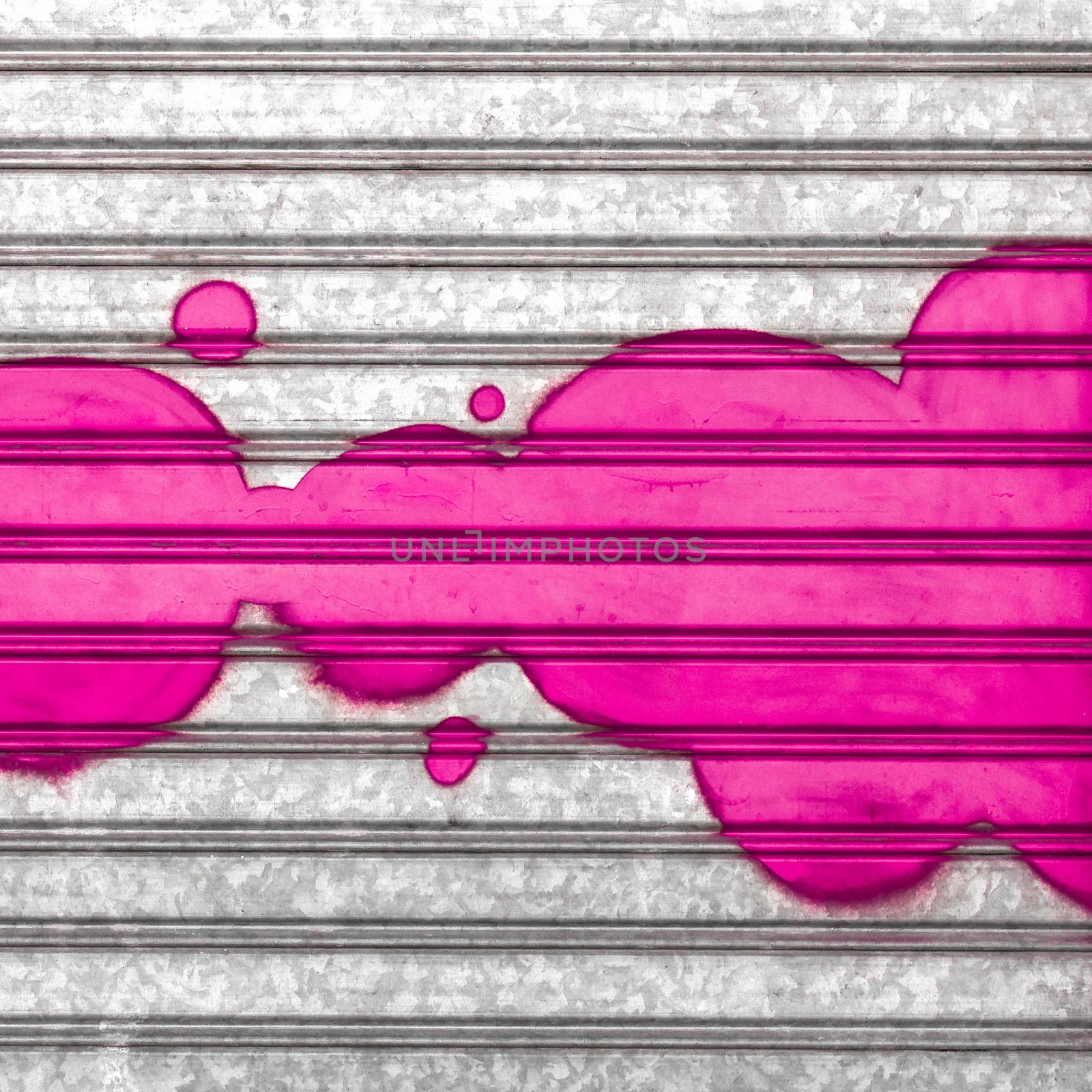 Pink bubbles painted with spray paint on a roller shutter. Ideal for your creative backgrounds.