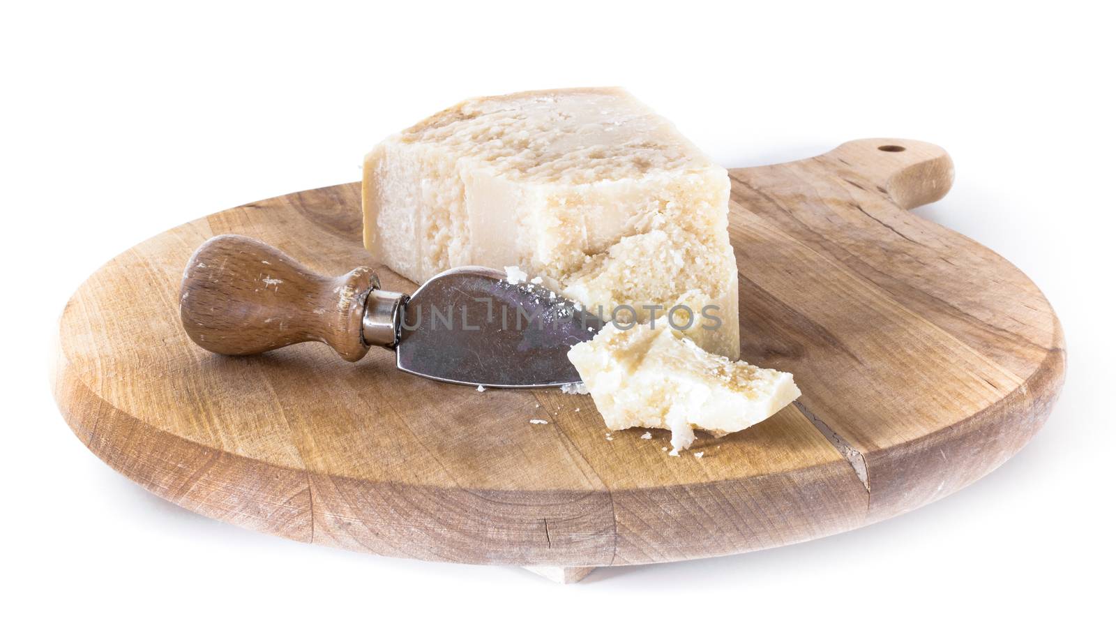 Wooden cutting board with flaked Parmesan.
