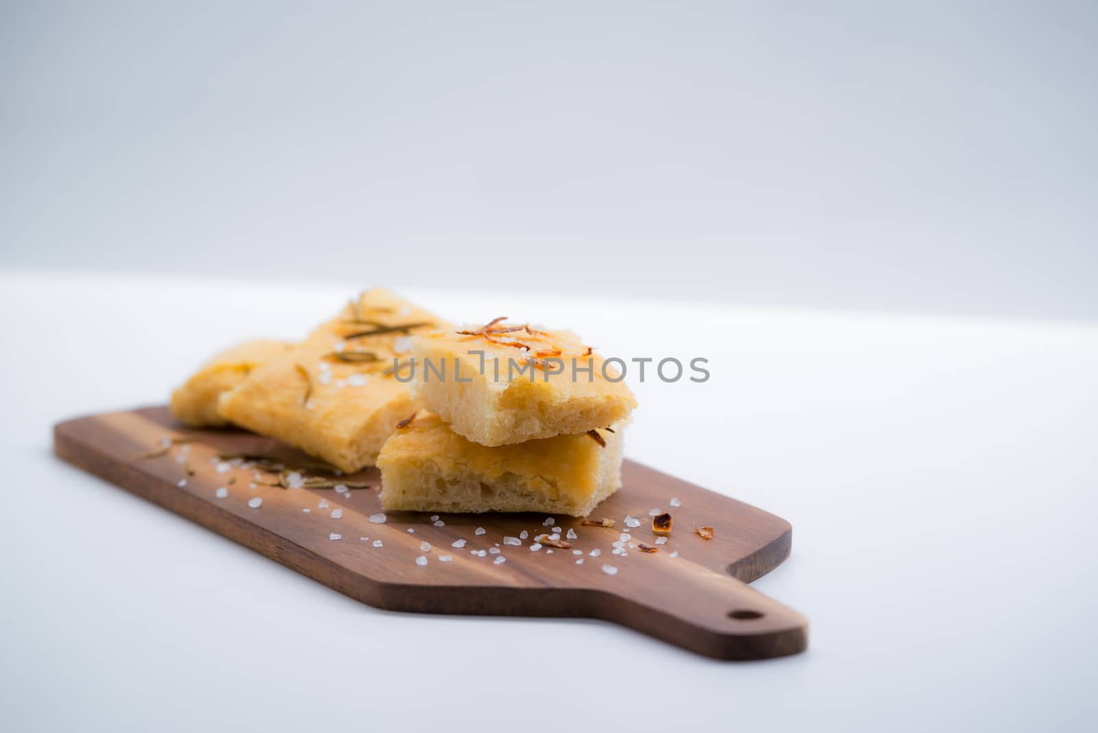 Italian focaccia with onion over a cutting board