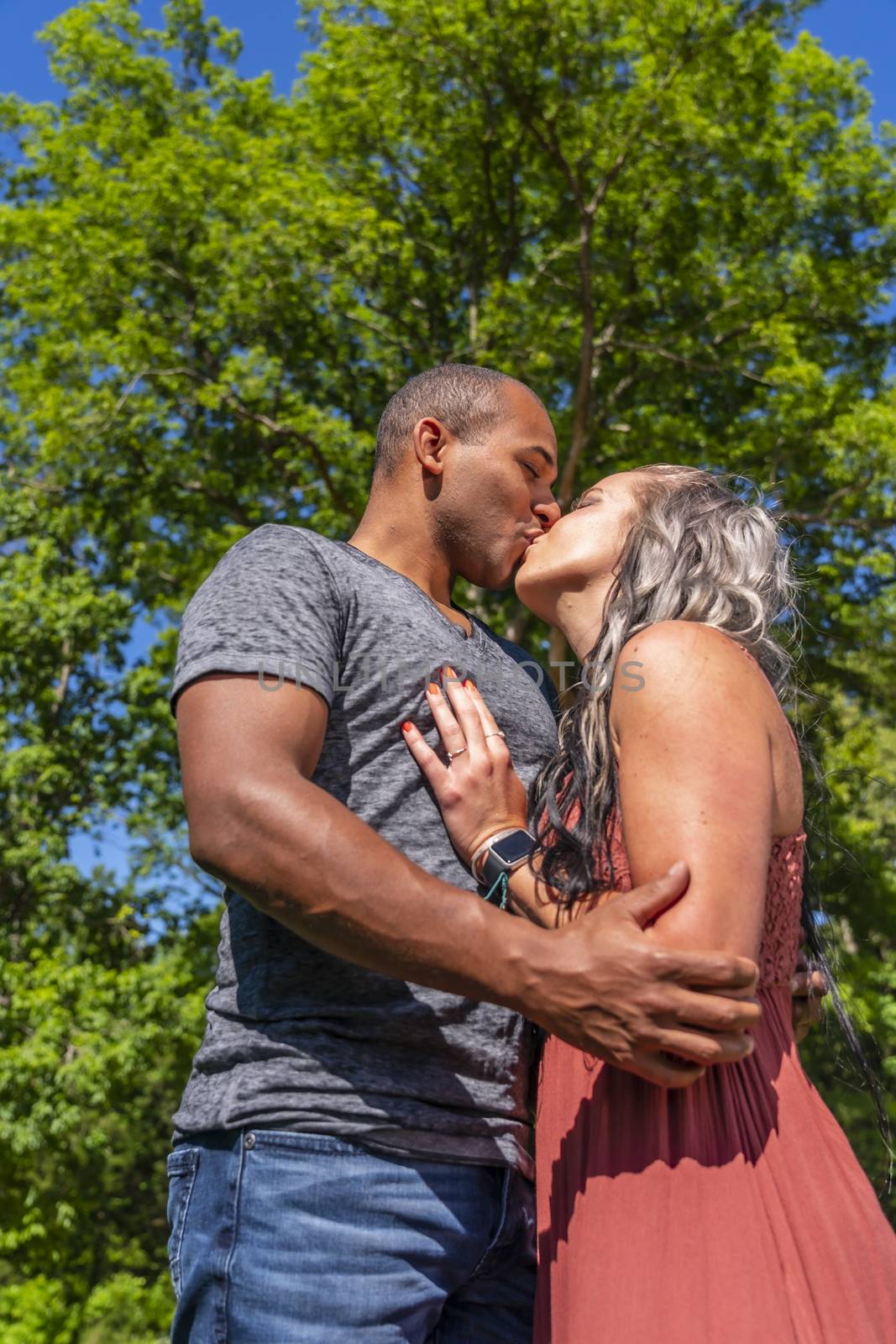 An interracial couple enjoying each others company on a summers day