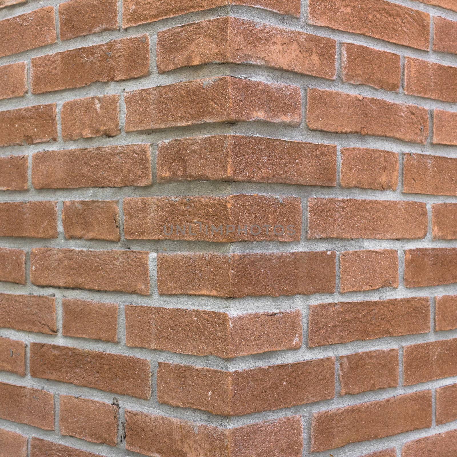 Front view of a wall with bricks arranged in a regular mode.