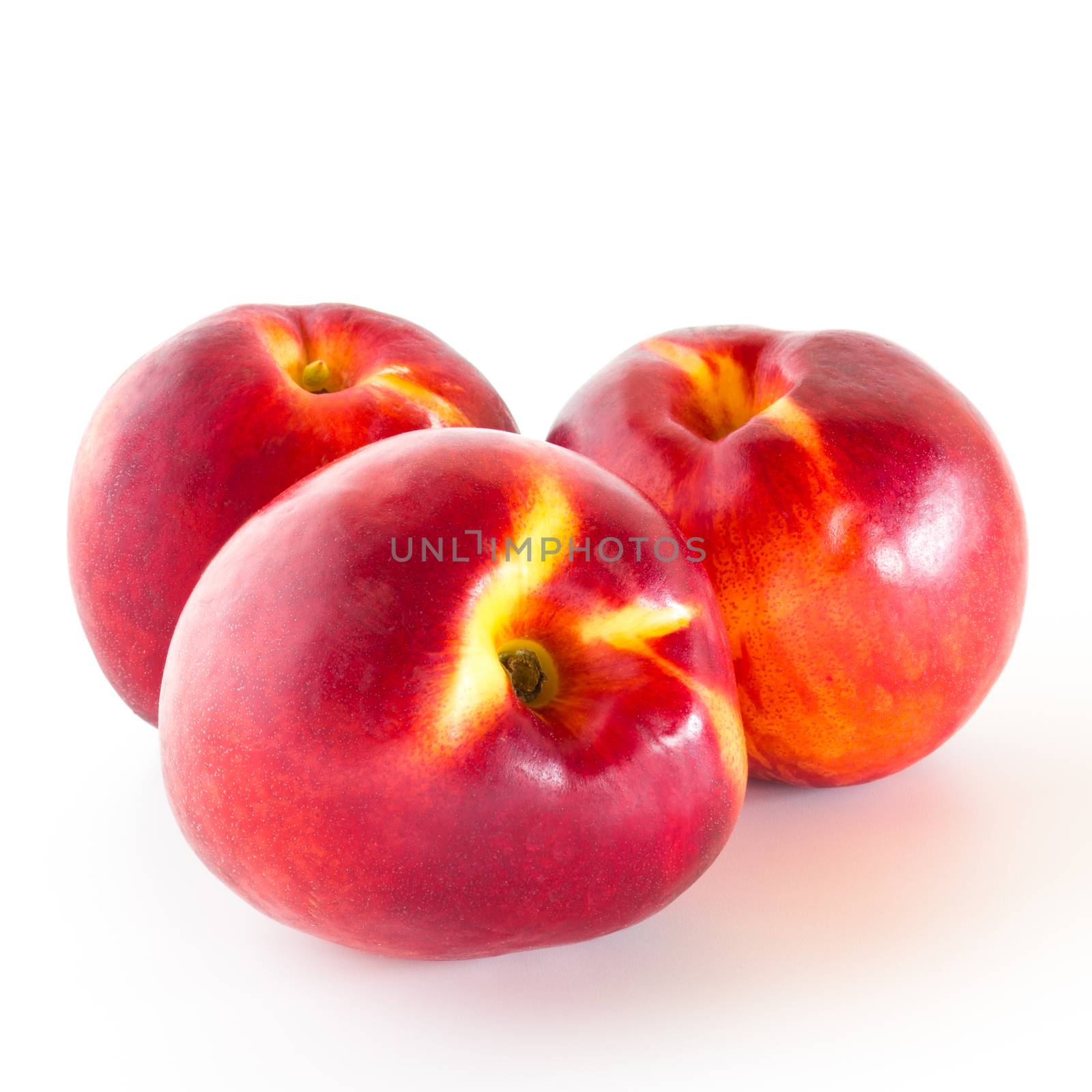 Group of three nectarines isolated on white background.