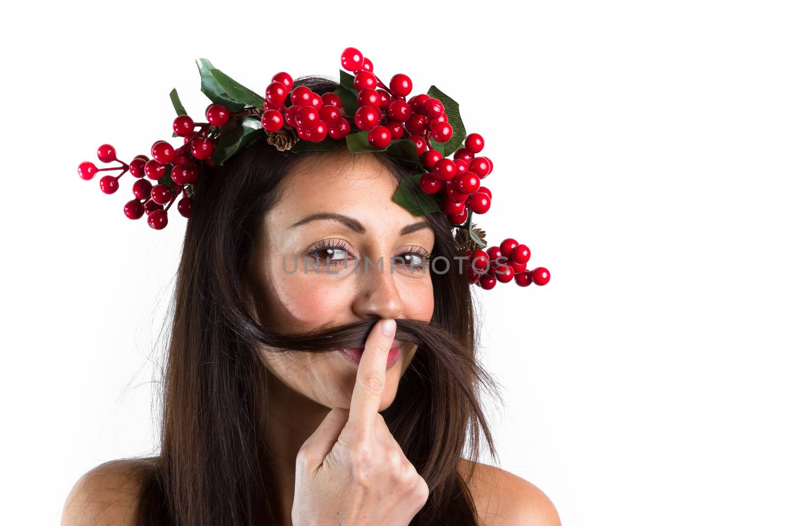 Christmas or New Year beauty woman portrait isolated on white background. Smiling young woman with wearing a Christmas wreath on her head, playing with her hair. Natural makeup.