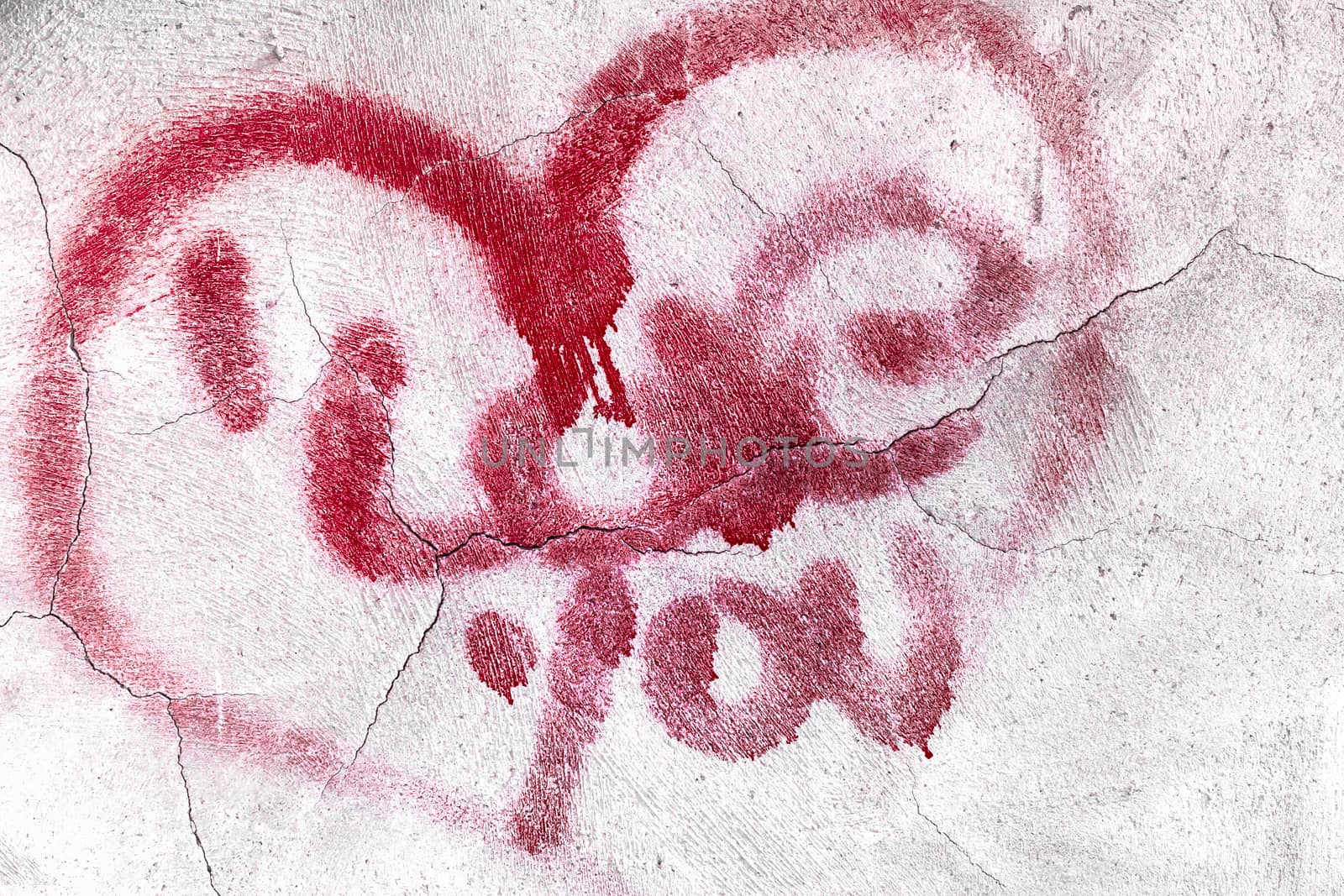 Red broken heart symbol with love message on textured cracked wall background