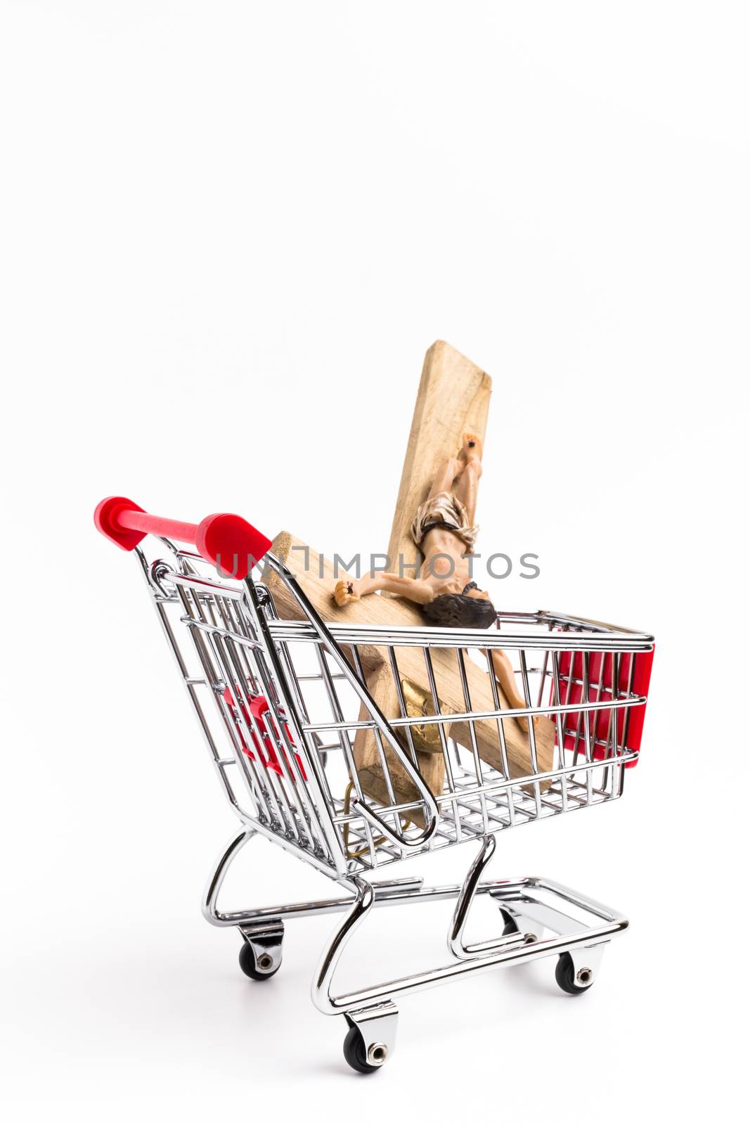 Crucifix in shopping cart. Conceptual representation of commodification of religion, loss of faith, blasphemy.