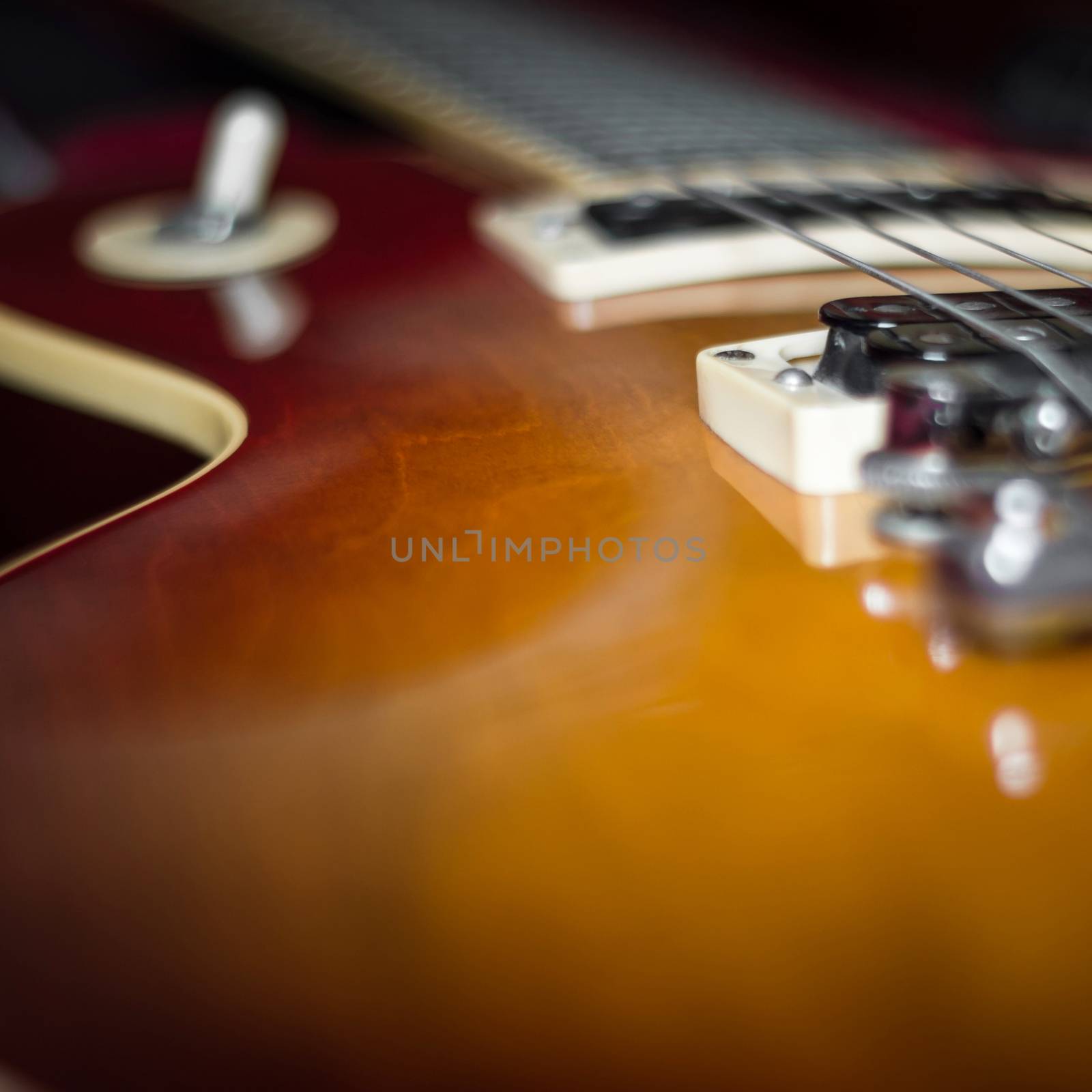 Close-up of the pickup selector and bridge of an electric guitar.