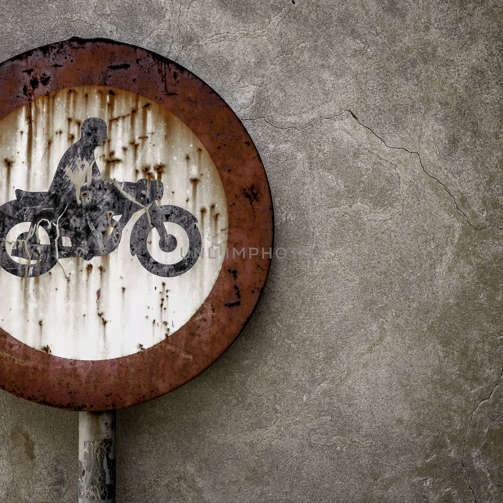 Road sign ban for motorcycles, rusted from the elements.