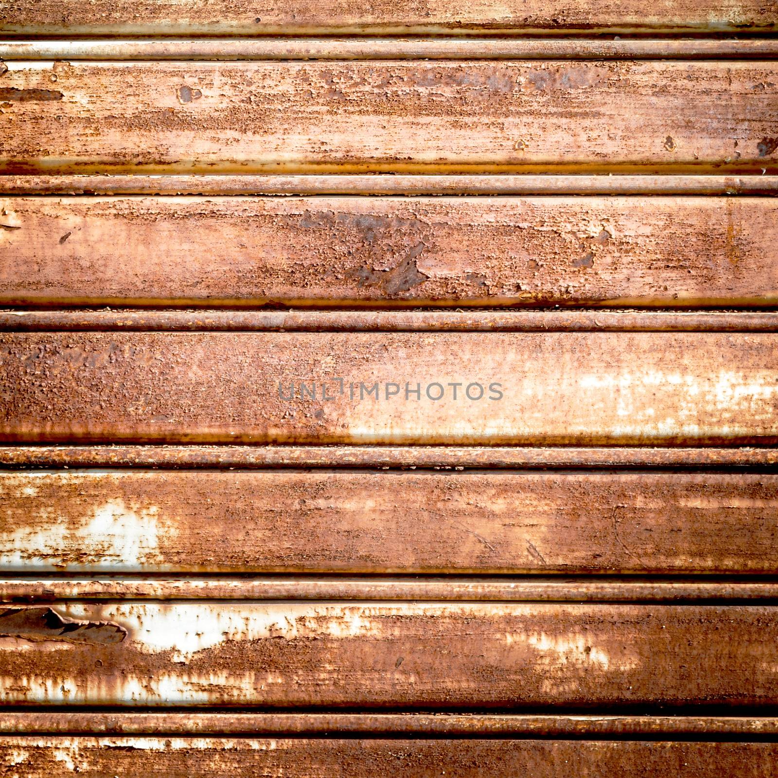 Background photo of a rusty old iron rolling shutter