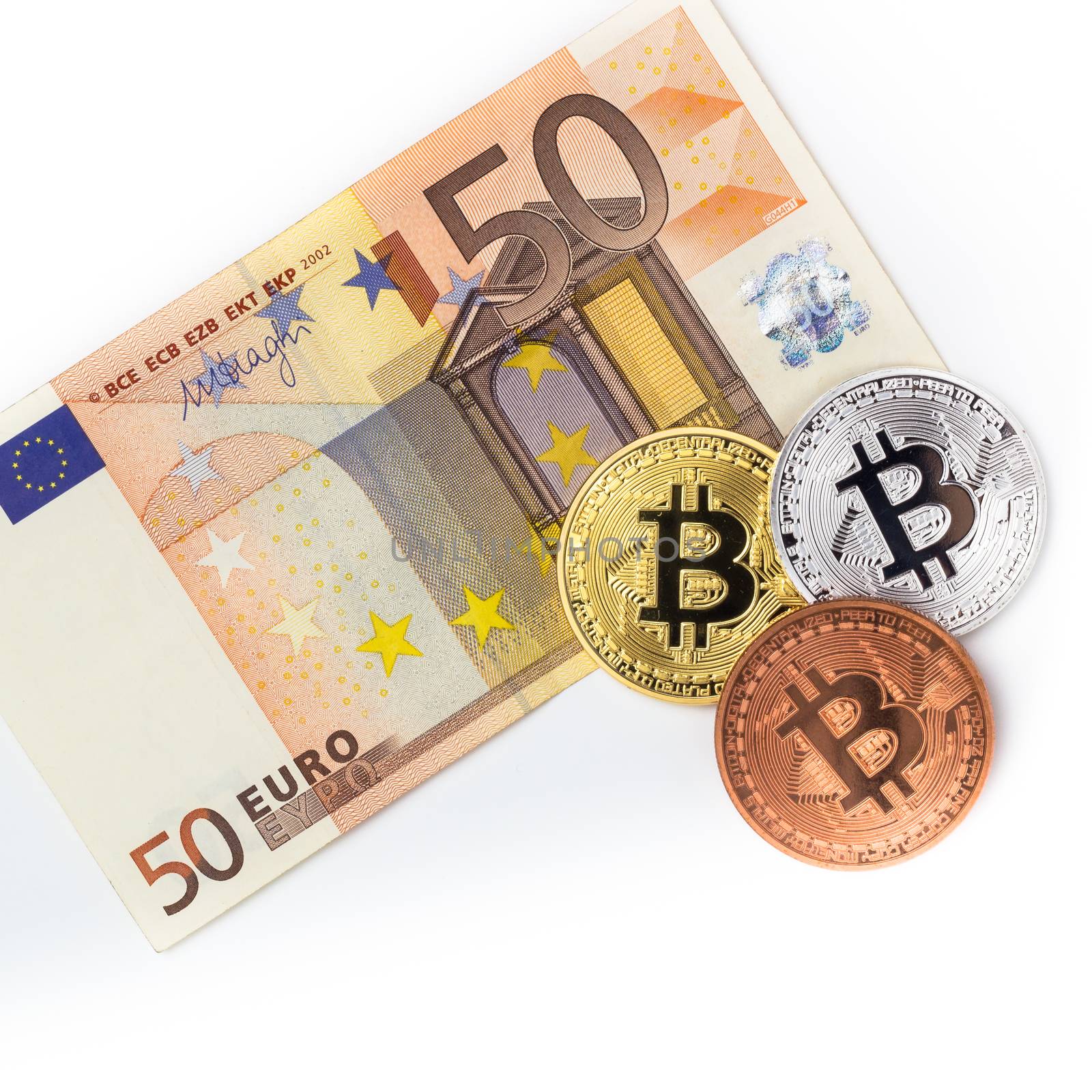 Financial concept with Bitcoins on fifty euro banknote. Traditional money vs cryptocurrency concept.