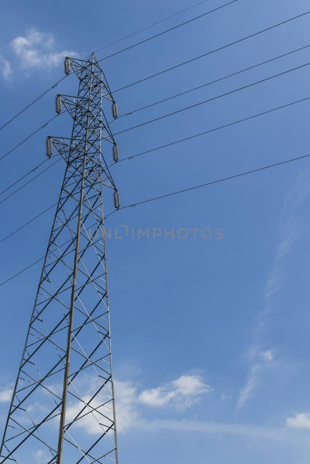 Pylon with blue sky and clouds in the background.