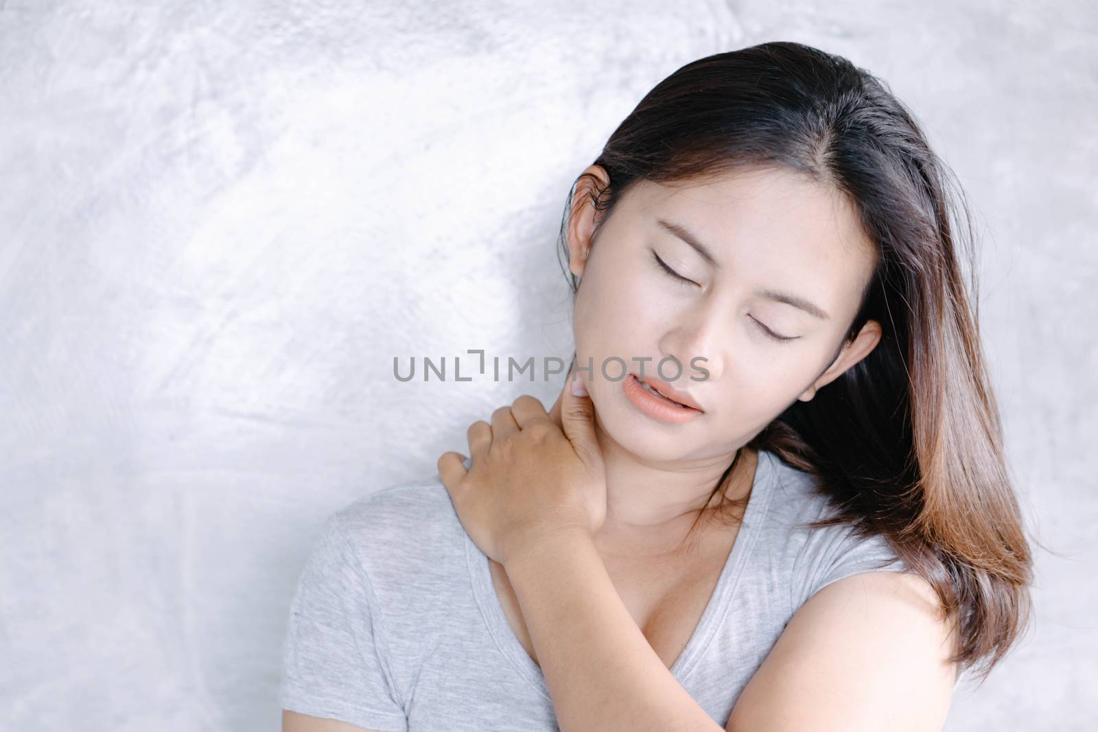 Closeup woman holding neck with pain, healthy care and medical concept
