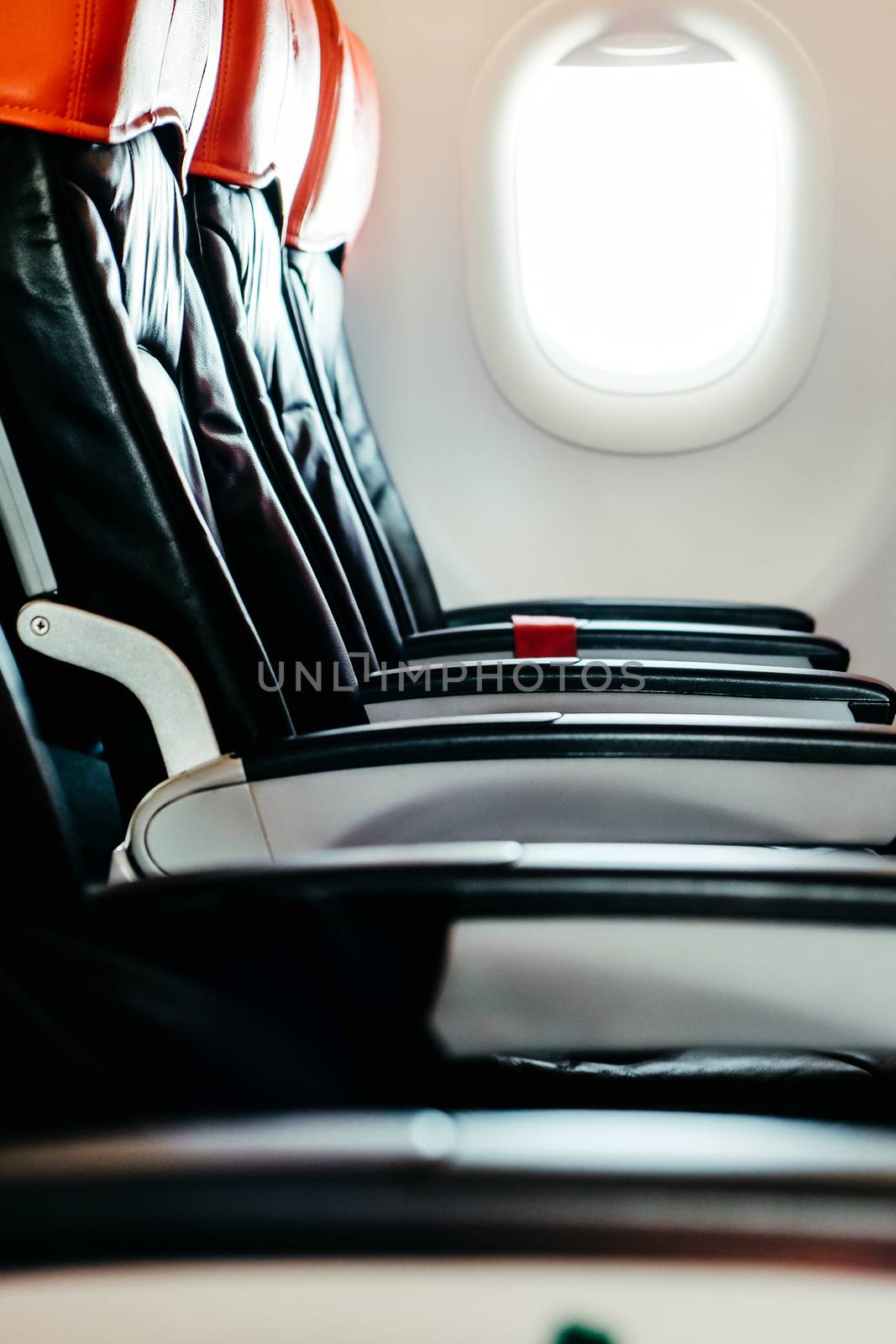 Seats in economy class section of airplane by ponsulak