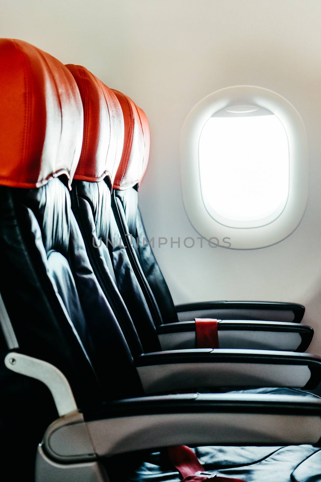 Seats in economy class section of airplane by ponsulak