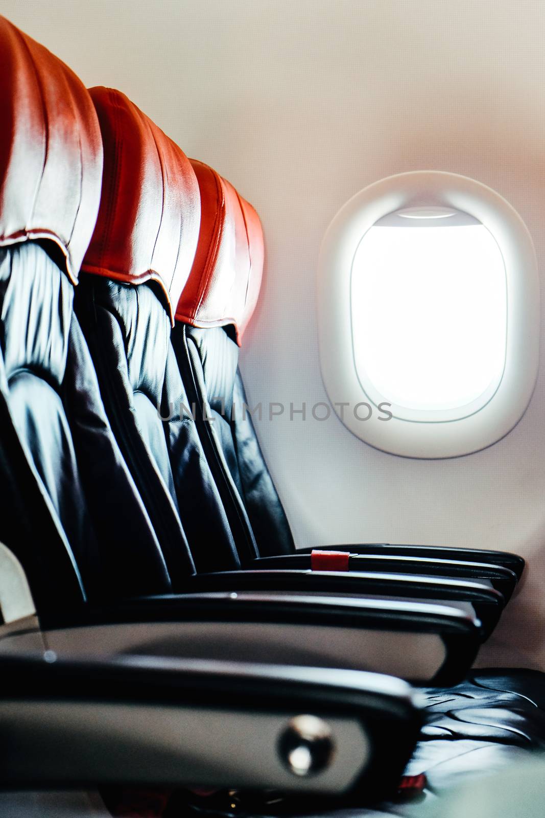 Seats in economy class section of airplane by ponsulak