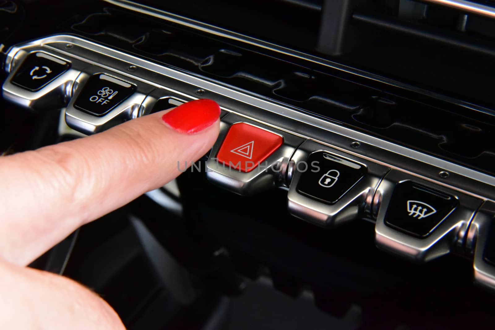 Woman pressing red triangle car hazard warning button by aselsa