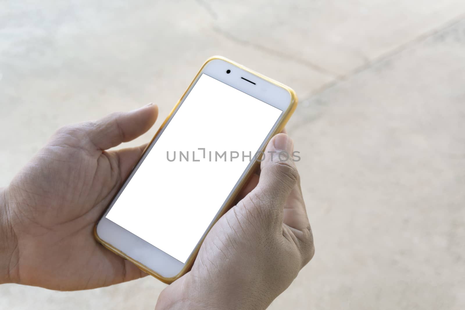 Closeup of men's hands, businessman holding a smartphone with a clean white screen and a white screen with a mockup design, stay outdoors to play social media or check stock, along with the vivid visual style on the street background.