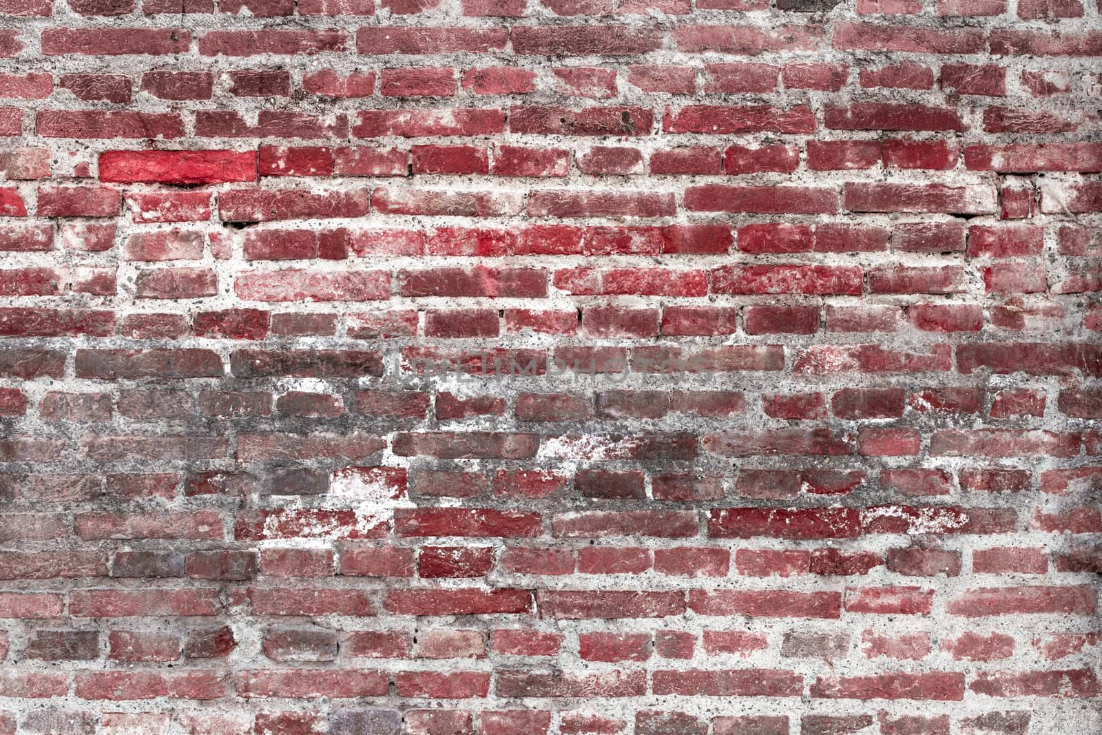 Details of the surface of an old wall in stones red and gray.