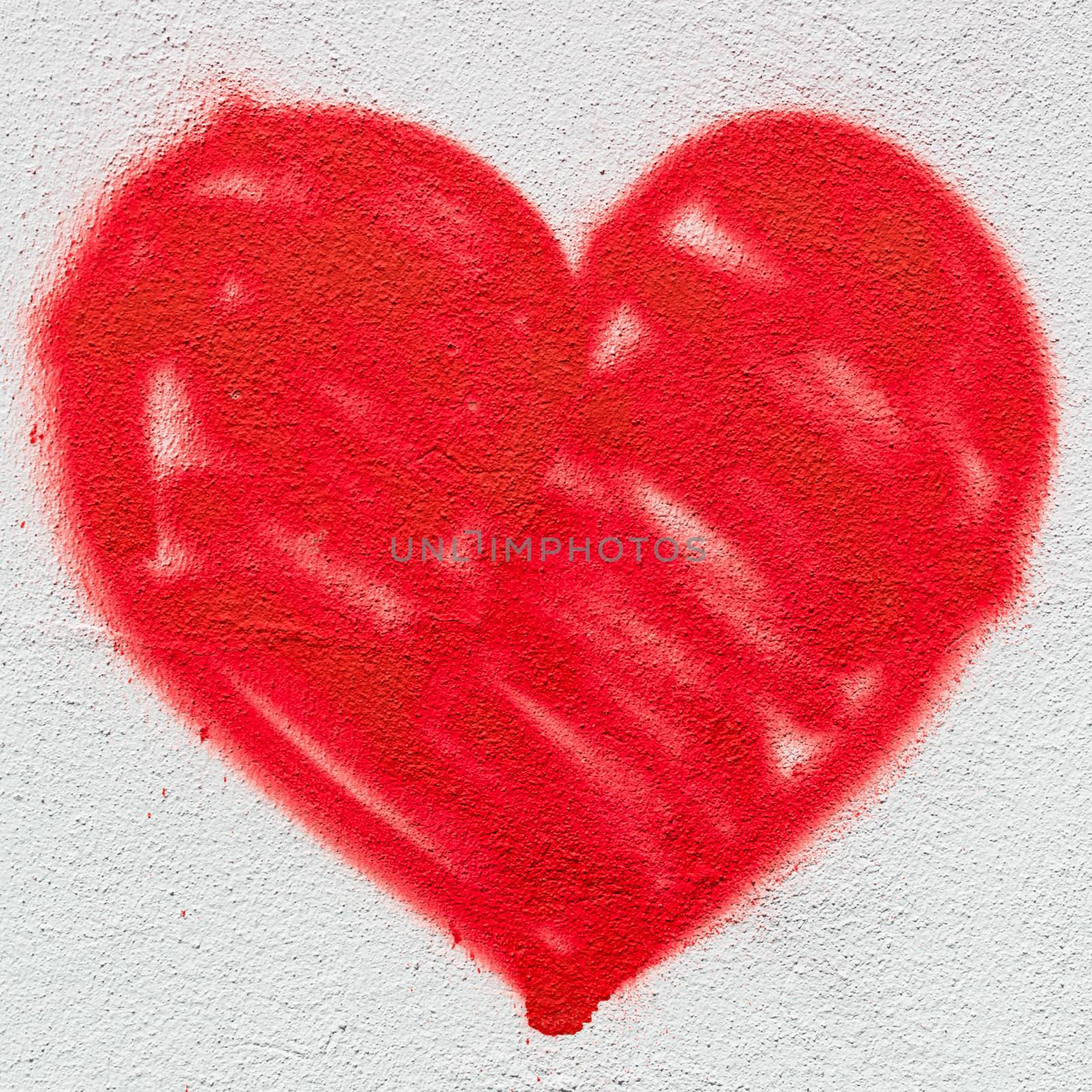 A big red heart, painted on the wall with spray paint.