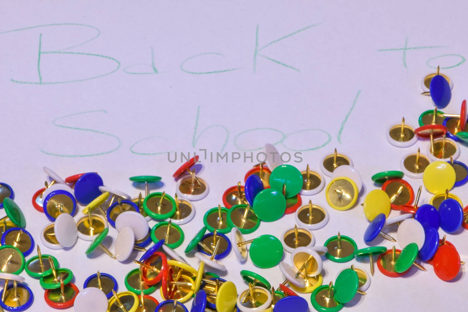 thumbtacks scattered on a white paper with the words "back to sc by brambillasimone