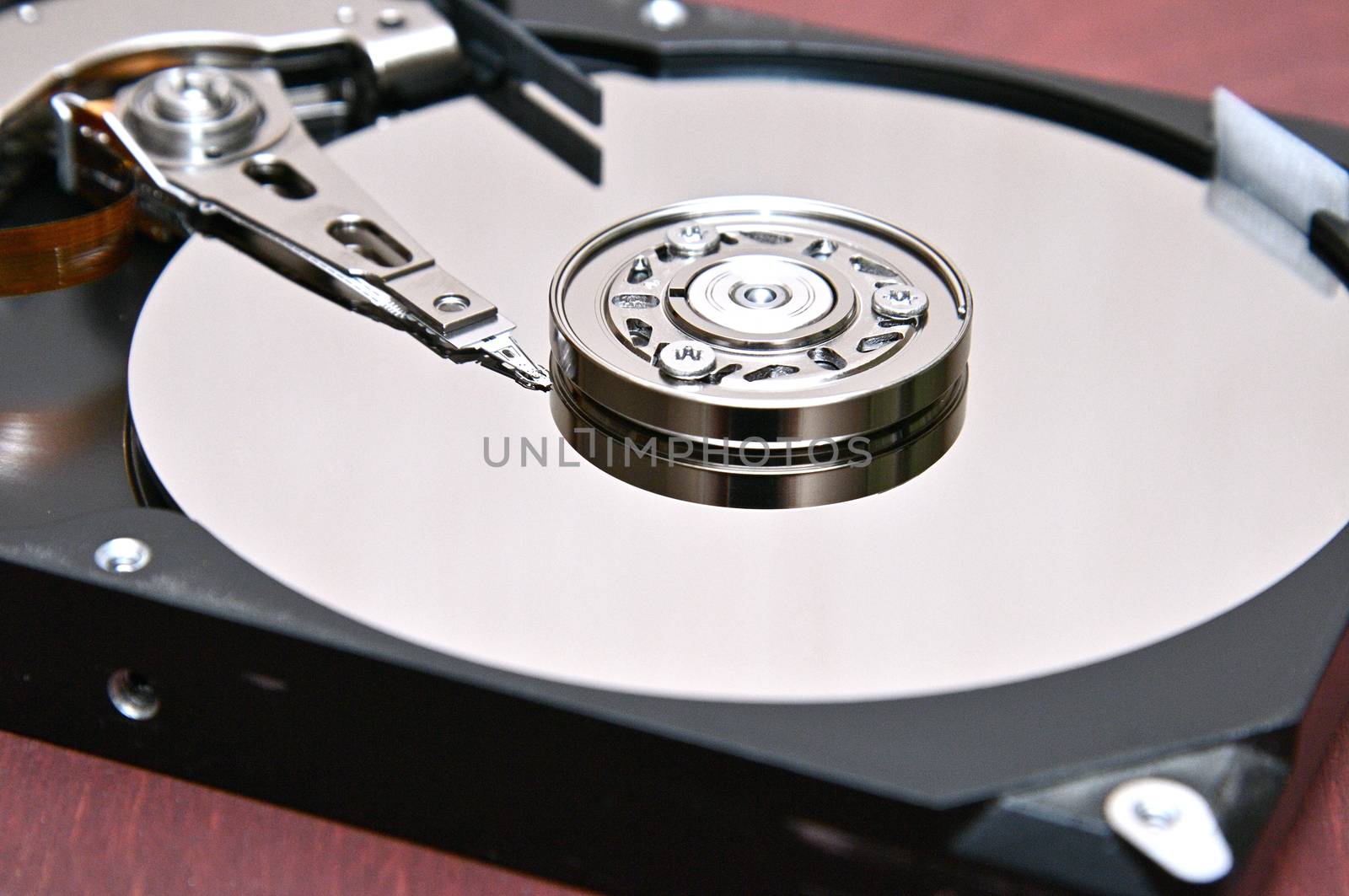 Internal parts of a hard disk on an isolated braun,wood background.