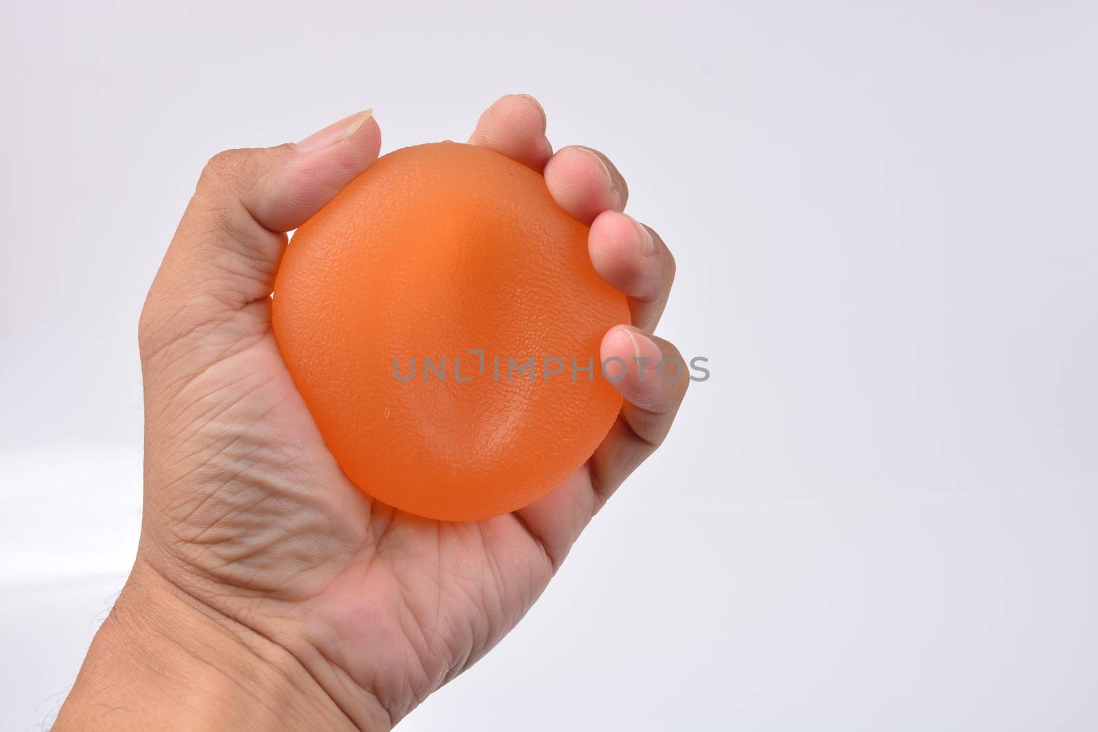 Hands of a man squeezing a stress ball, Hand Strength Therapy Squeeze Grip Ball