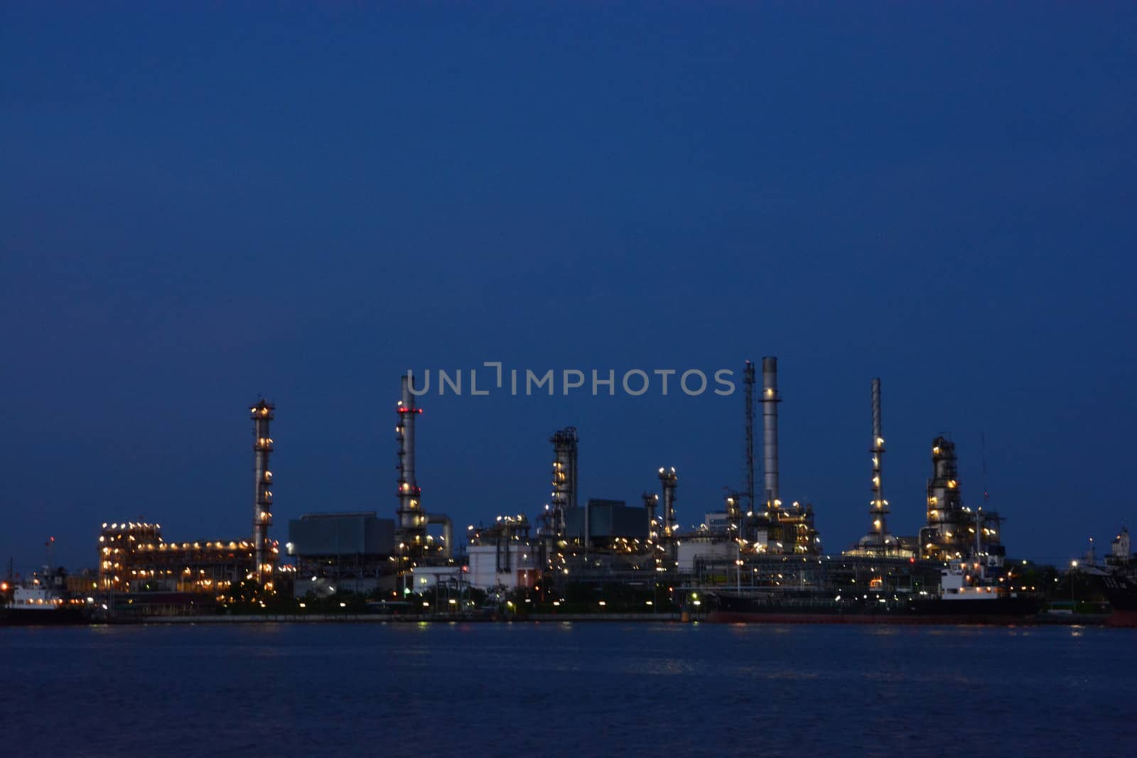 Oil Refinery factory in the evening , petrochemical plant , Petroleum.