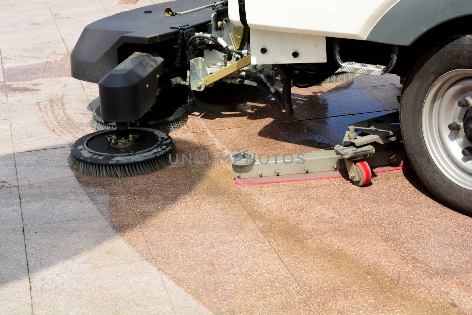 urban sweeper cleans road from dirt with a round brush