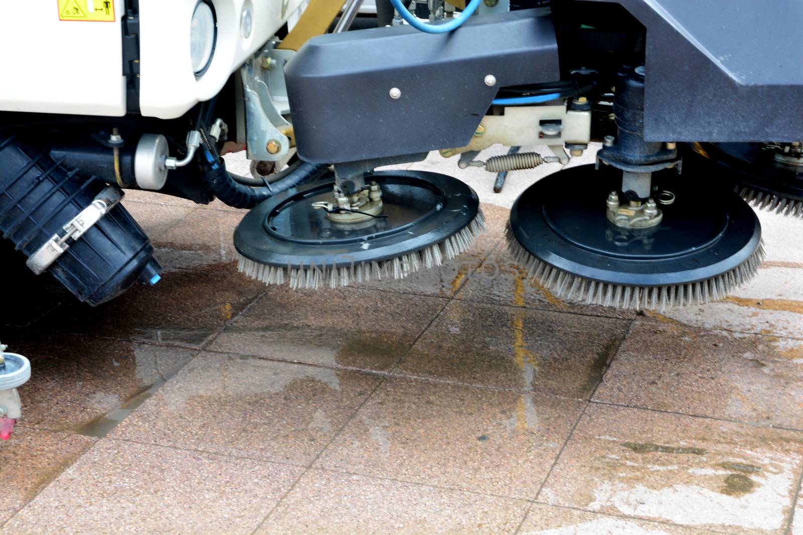 urban sweeper cleans road from dirt with a round brush