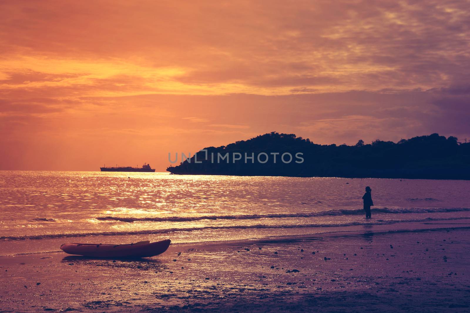 Silhouette of the woman beautiful sunset on the beach by ideation90