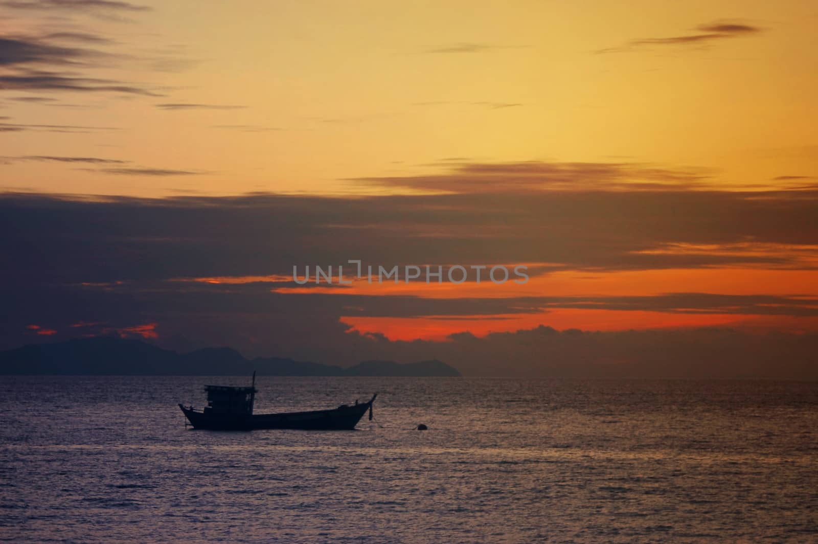 Dark silhouettes of boat and amazing cloudy sky on sunset  in the sea. by ideation90