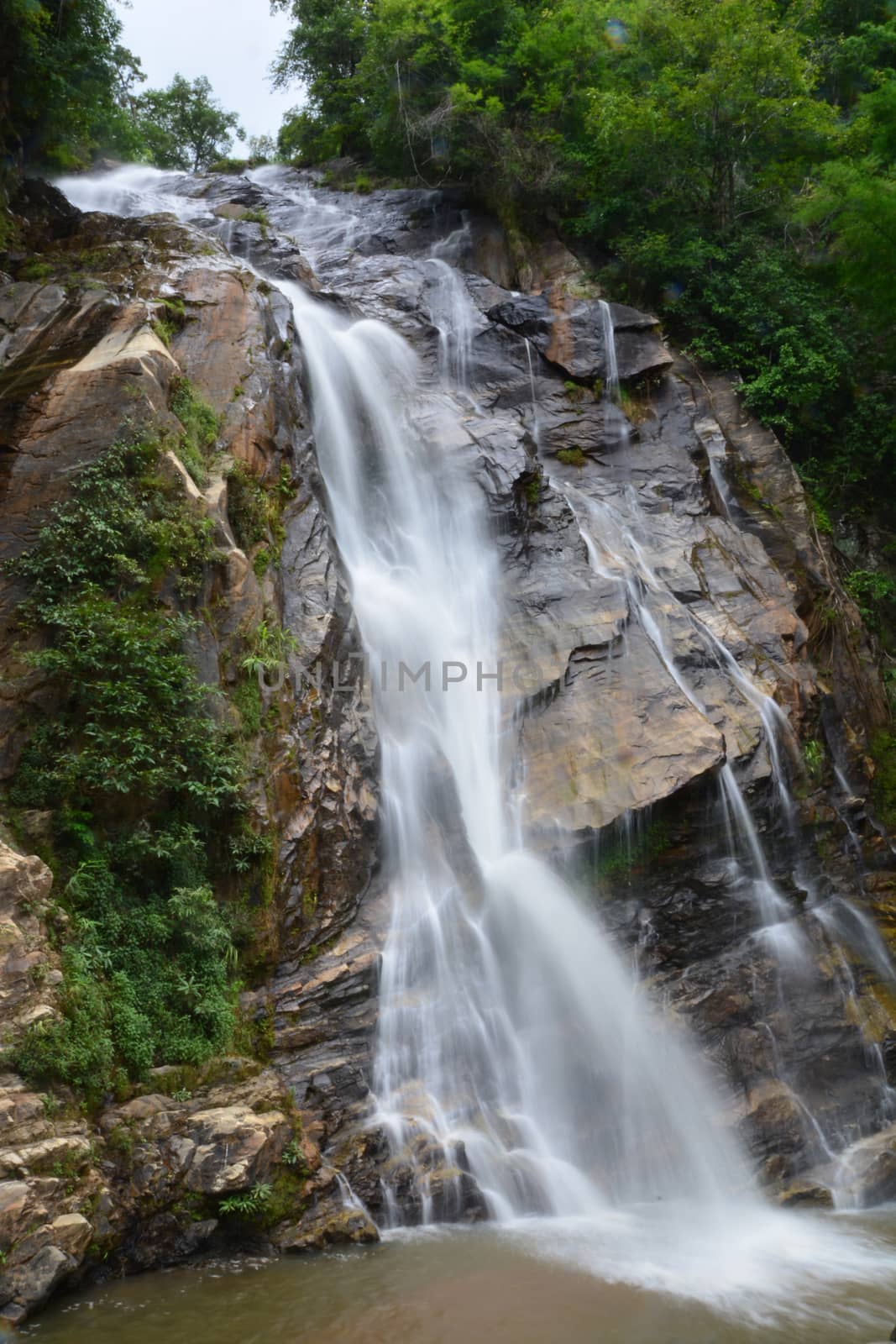 Mae Tia Waterfall Natural beauty of the streams flows gently joins the others and drops to reefs as layers of water that hit the reefs resulting in a terrifying sound inserted by appropriate movement