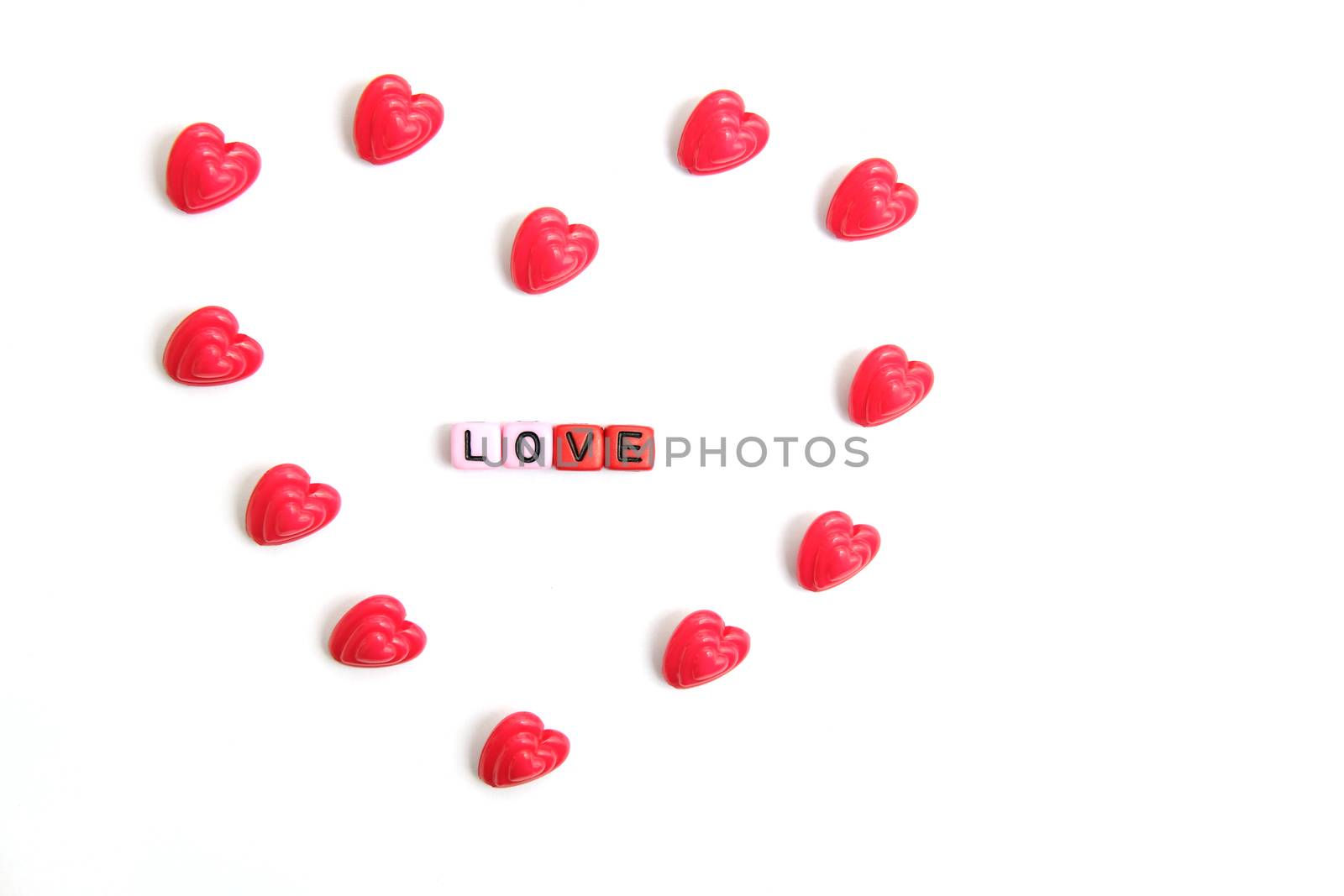 Red and pink heart beads shape, top view flat lay with white background. Love and romance conceptual object