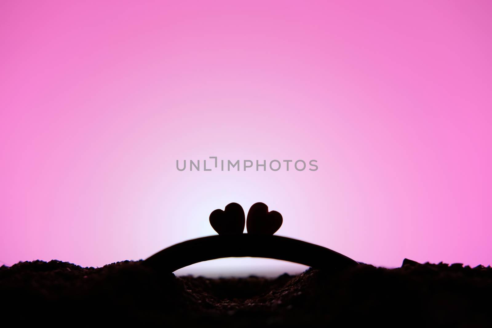 miniature people / toy photography - conceptual valentine holiday illustration. two heart silhouette above the bridge
