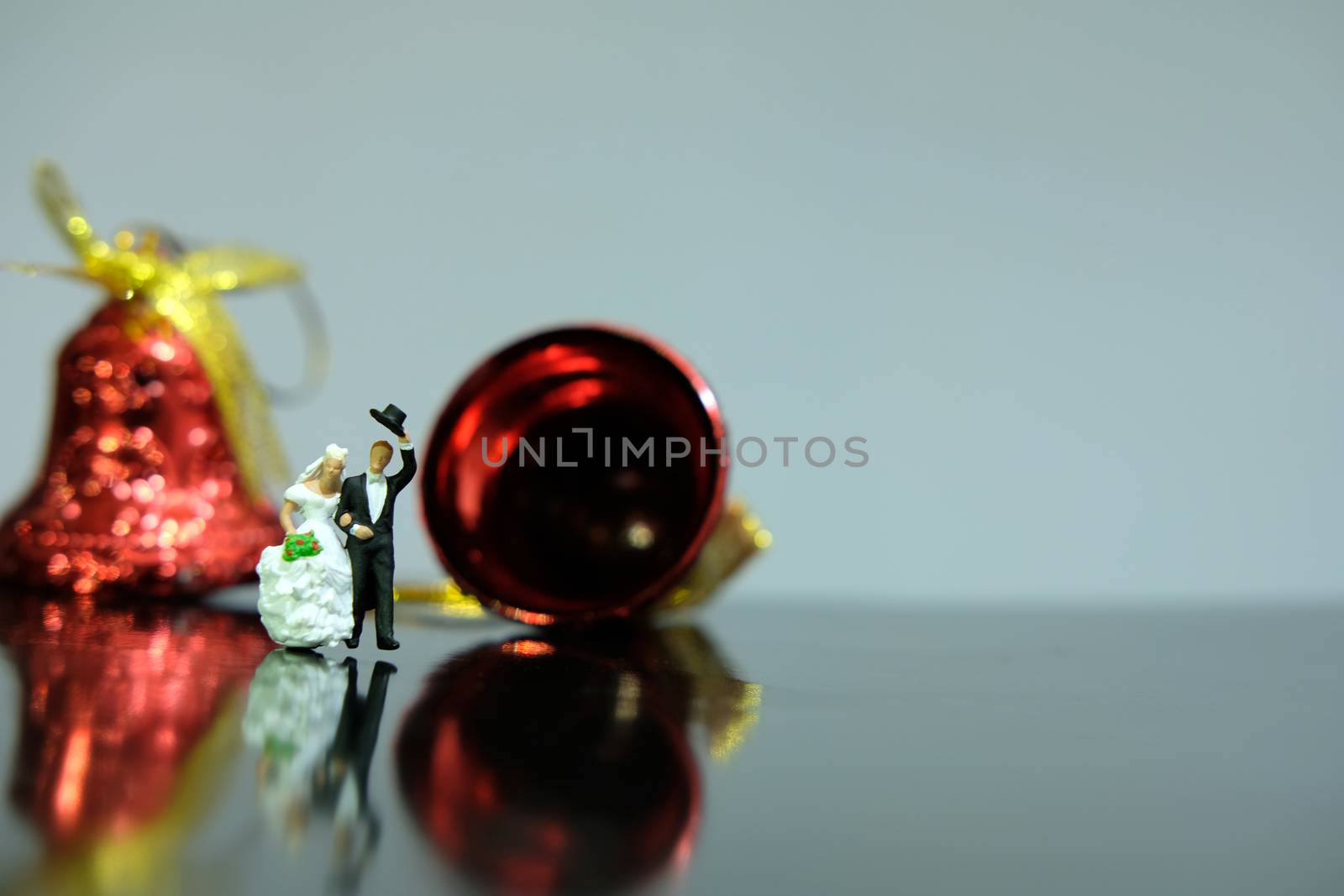 Miniature wedding concept. Bride and groom walking out make greeting after wedding procession. image photo by Macrostud
