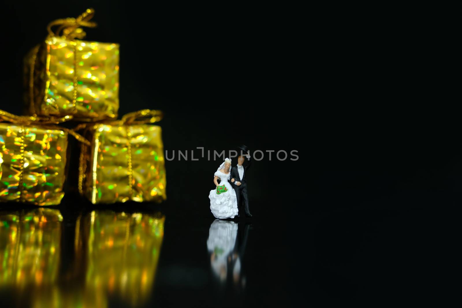 Miniature wedding concept. Bride and groom walking out make greeting after wedding procession. image photo by Macrostud