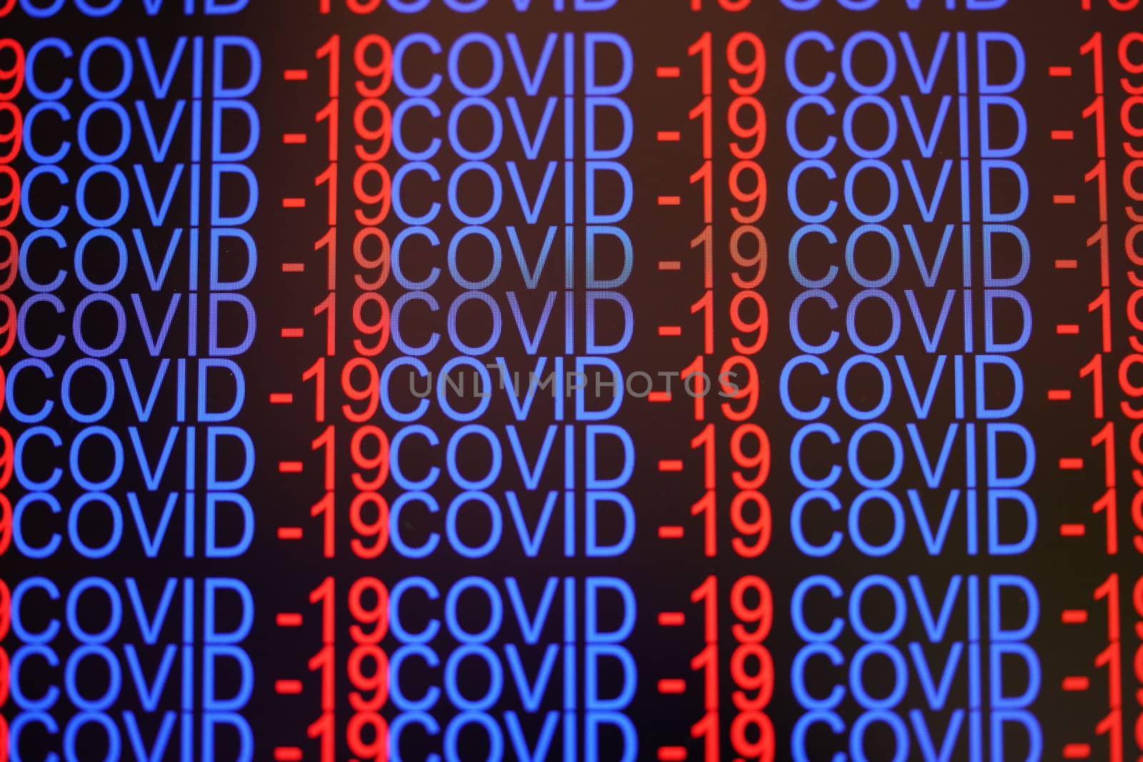 A close-up of the letters COVID-19 on the laptop screen.