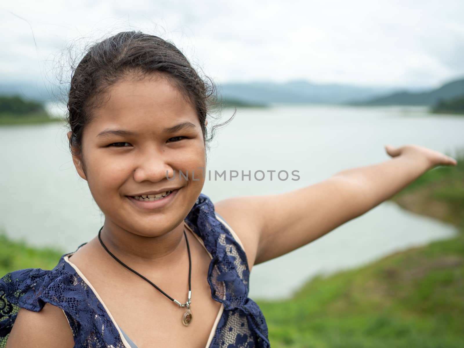 Asian woman Stand on the reservoir background at tourist places in thailand