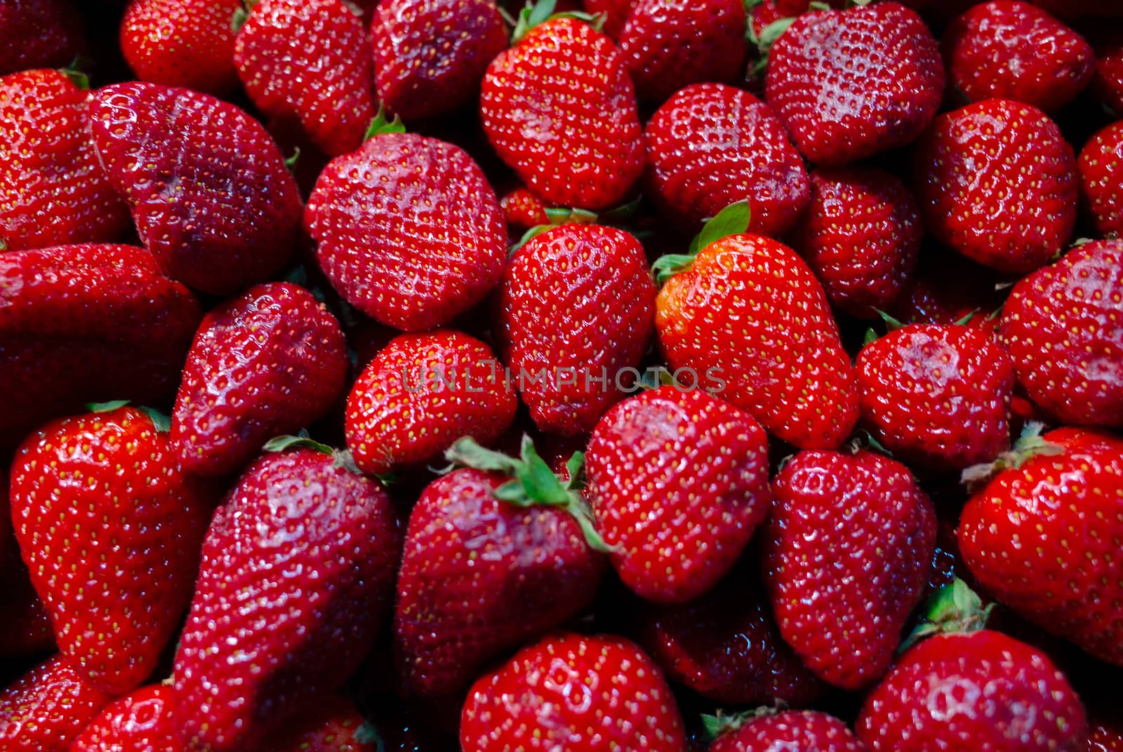 Bright red strawberries on the counter of a fruit shop.