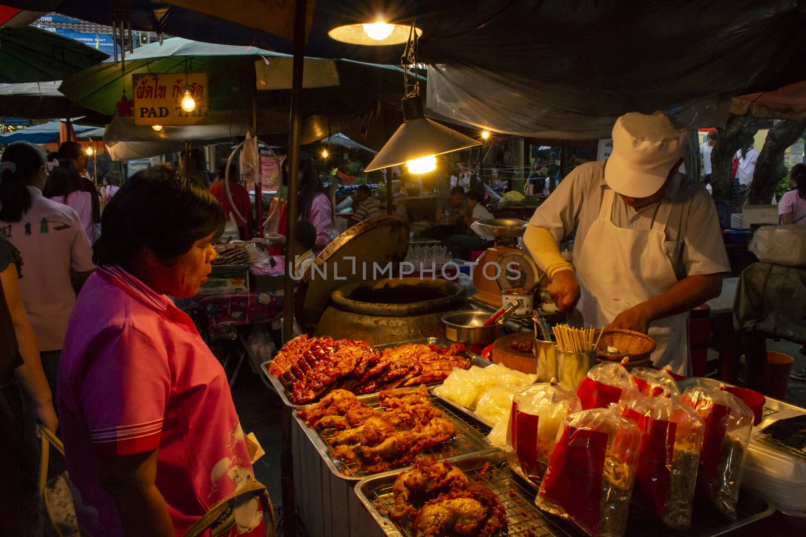 people at a food market stall in the streets of Bangkok, Thailand by kb79