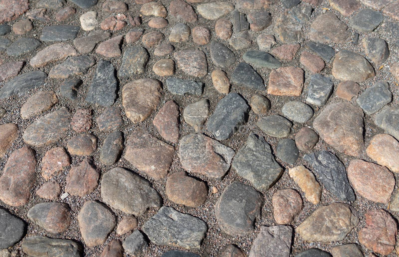 Old cobblestone pavement in the ancient European city