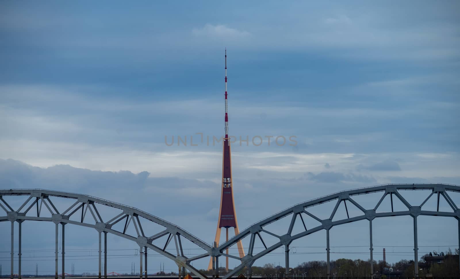 April 24, 2018 Riga, Latvia. View of the Riga Television Tower and the metal trusses of the railway bridge over the Daugava