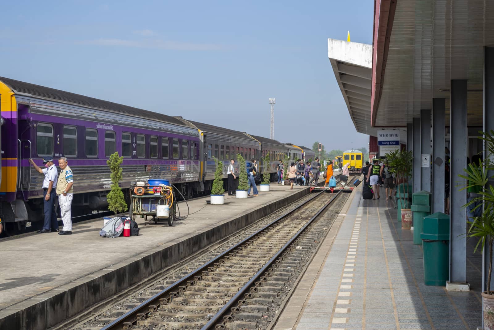 View on the platform of Nong Khai train station in Thailand with people boarding the train by kb79