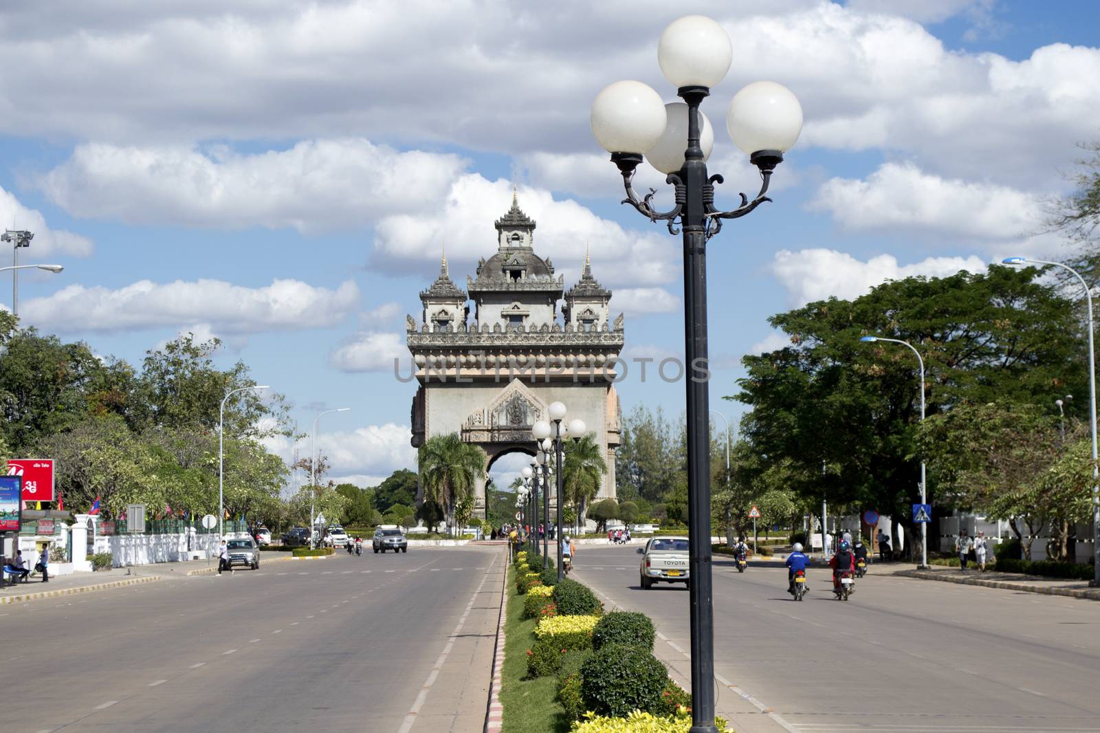 Vientiane, Laos, December 2011: Lane Xang Avenue with Patuxay Monument landmark arch and war memorial in the background.