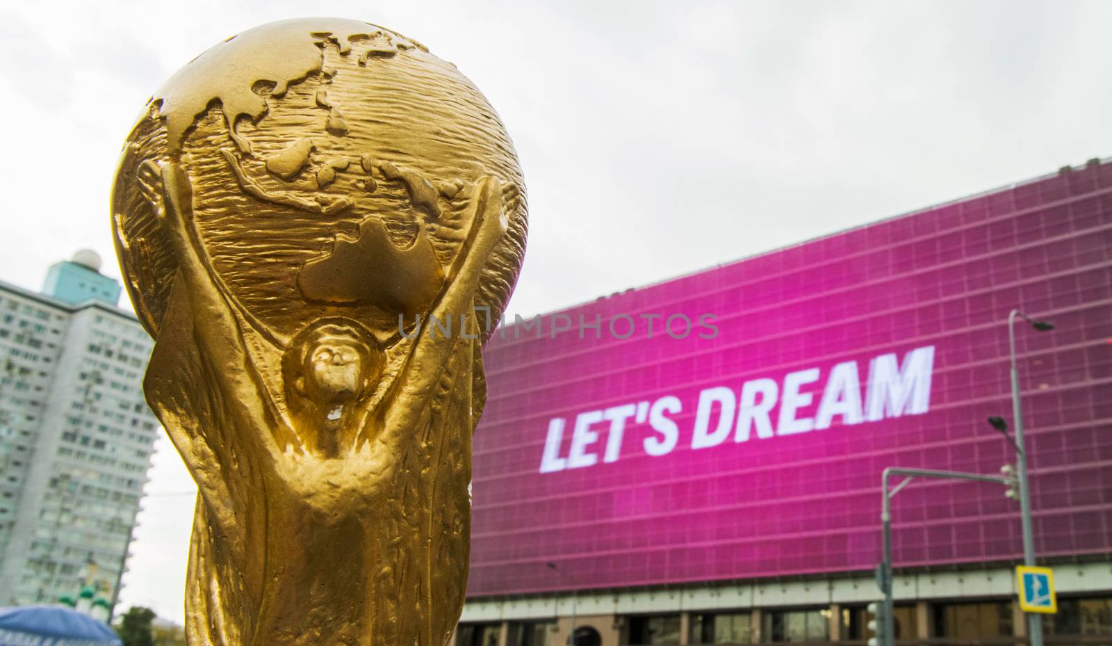 4 September 2019, Moscow, Russia. Copy of world cup trophy on background logo of the FIFA world Cup 2022, which will be held in Qatar, on a giant screen in the city center.