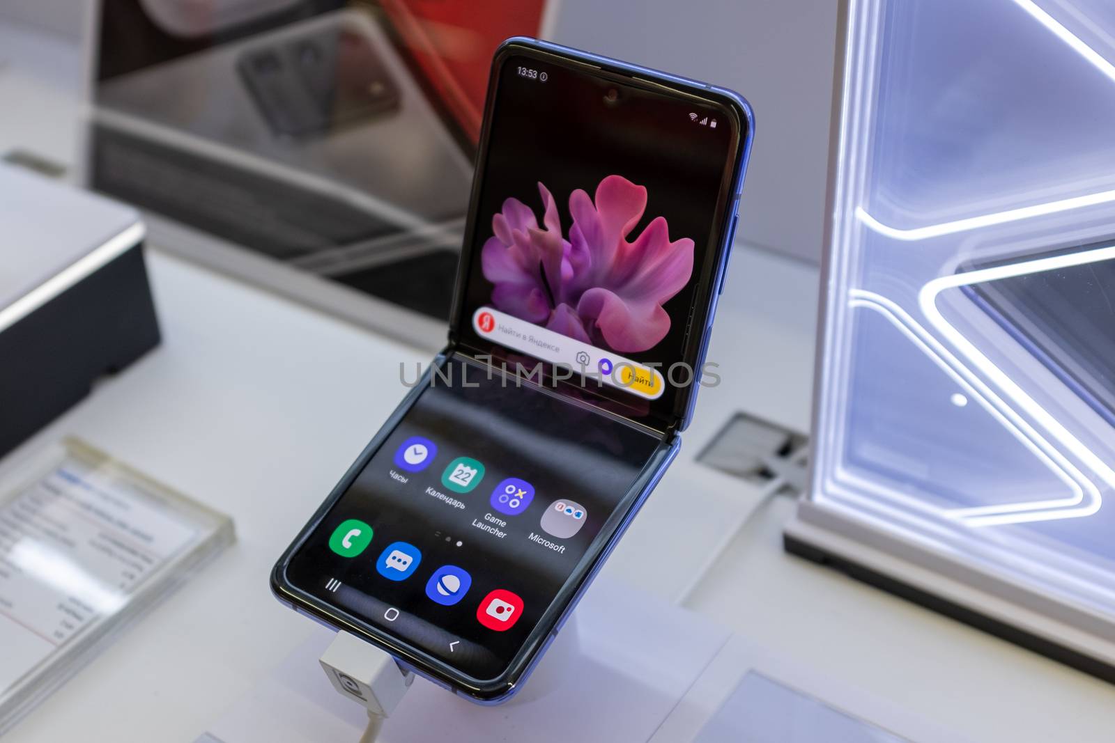 February 22, 2020, Moscow, Russia. New folding smartphone with a folding screen Samsung Galaxy Z Flip on the store counter.